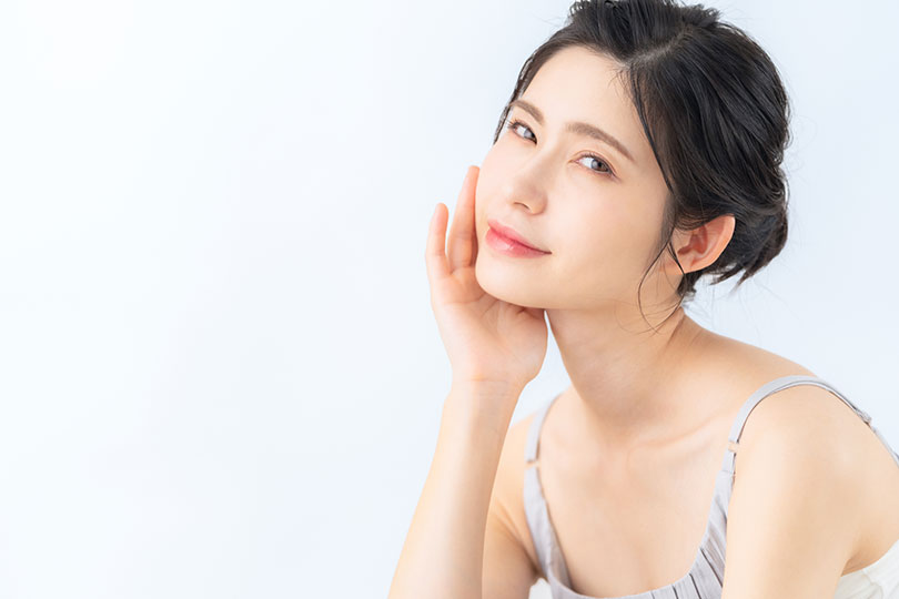 頬に手を添える美肌の女性